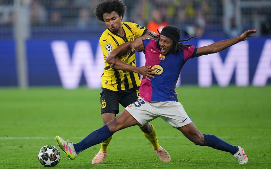 Kounde-disputa-a-bola-com-Adeyemi-em-Dortmund-x-Barcelona-pela-Champions-League-scaled-aspect-ratio-512-320